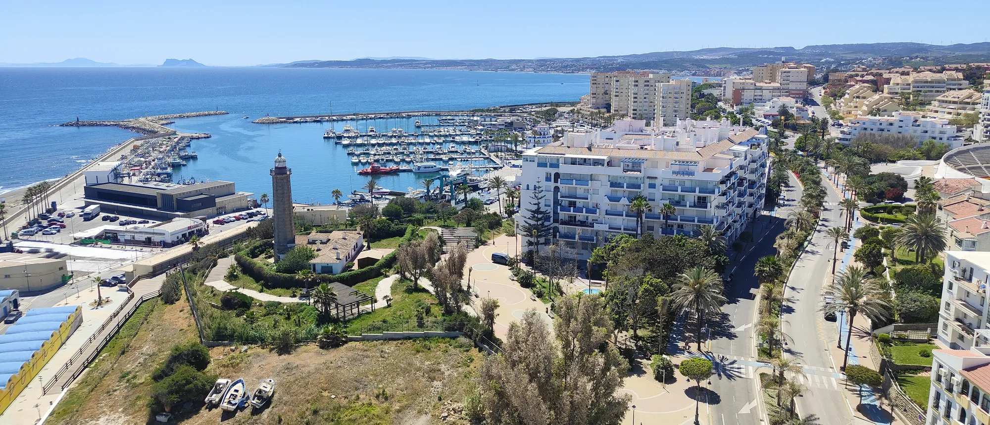 Aerial view of Estepona: the marina, the lighthouse, and the coastline to the Rock of Gibraltar