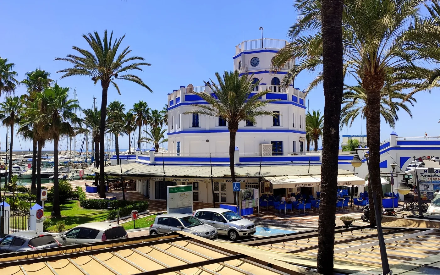 The Estepona marina and its palm trees, facing the yacht club