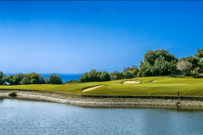 The Valle Romano golf course in Estepona: green, bunkers and water feature facing the Mediterranean